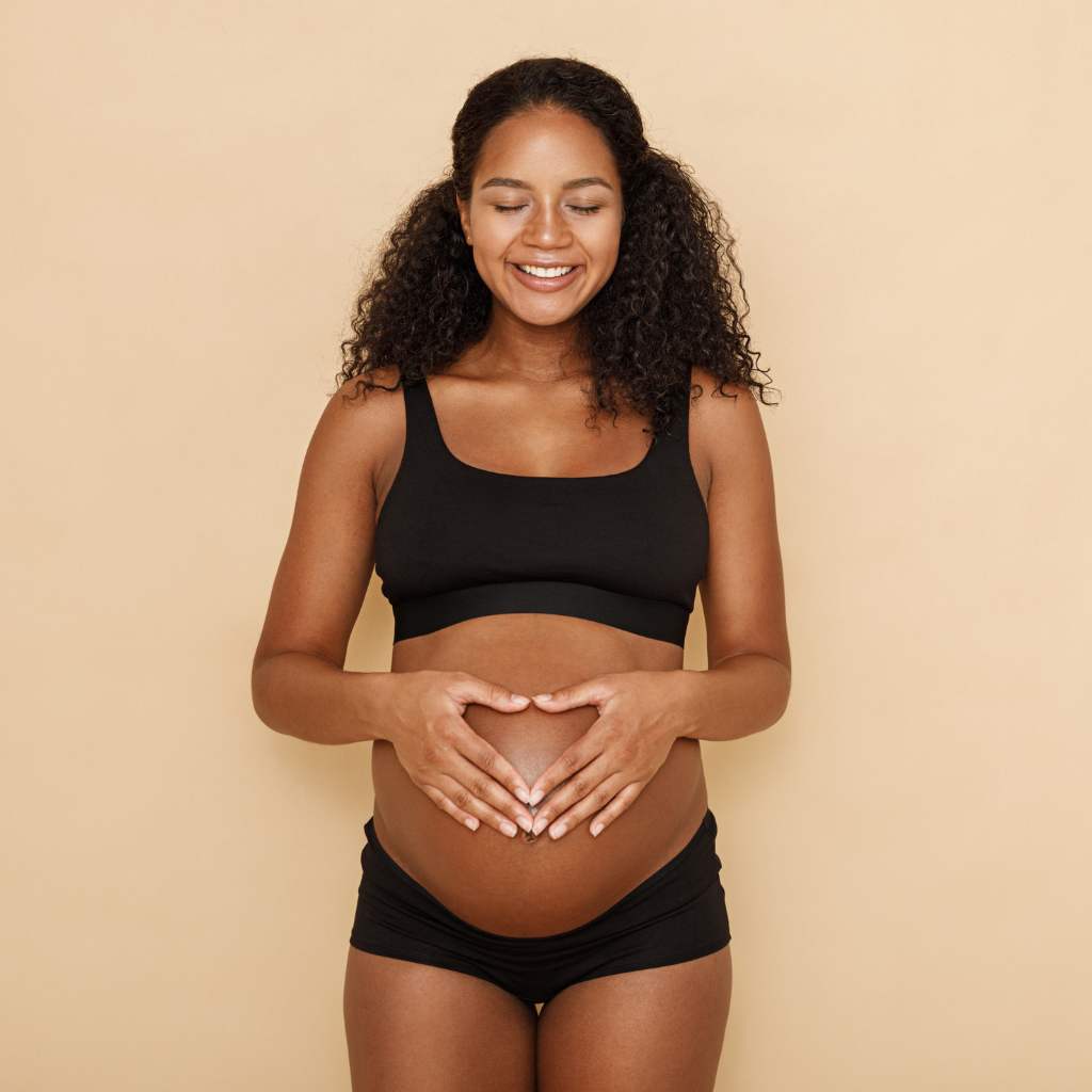 Image of pregnant woman holding her belly