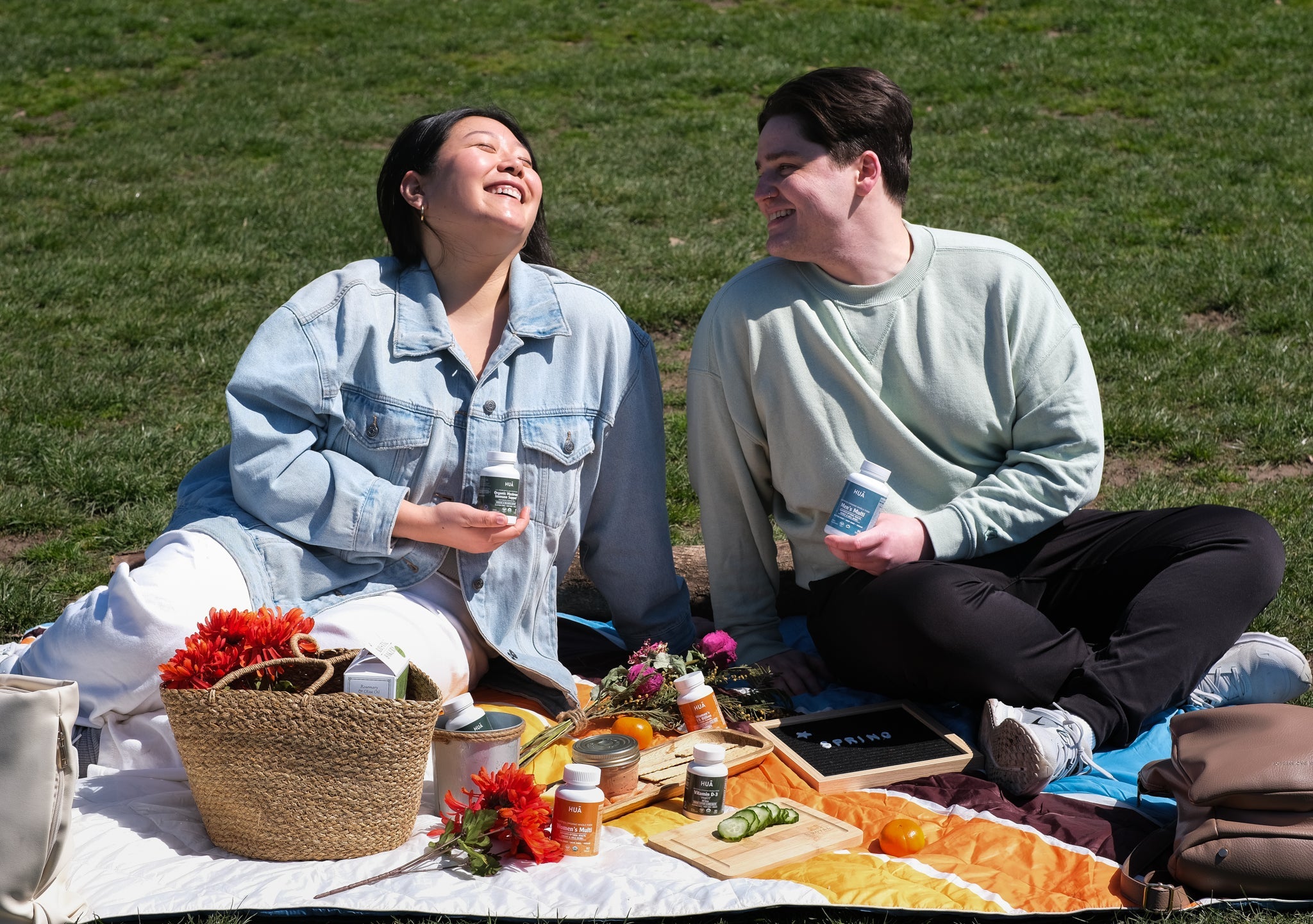Friends at picnic holding HUA Wellness products